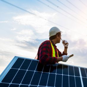 obrero apoyado en panel solar